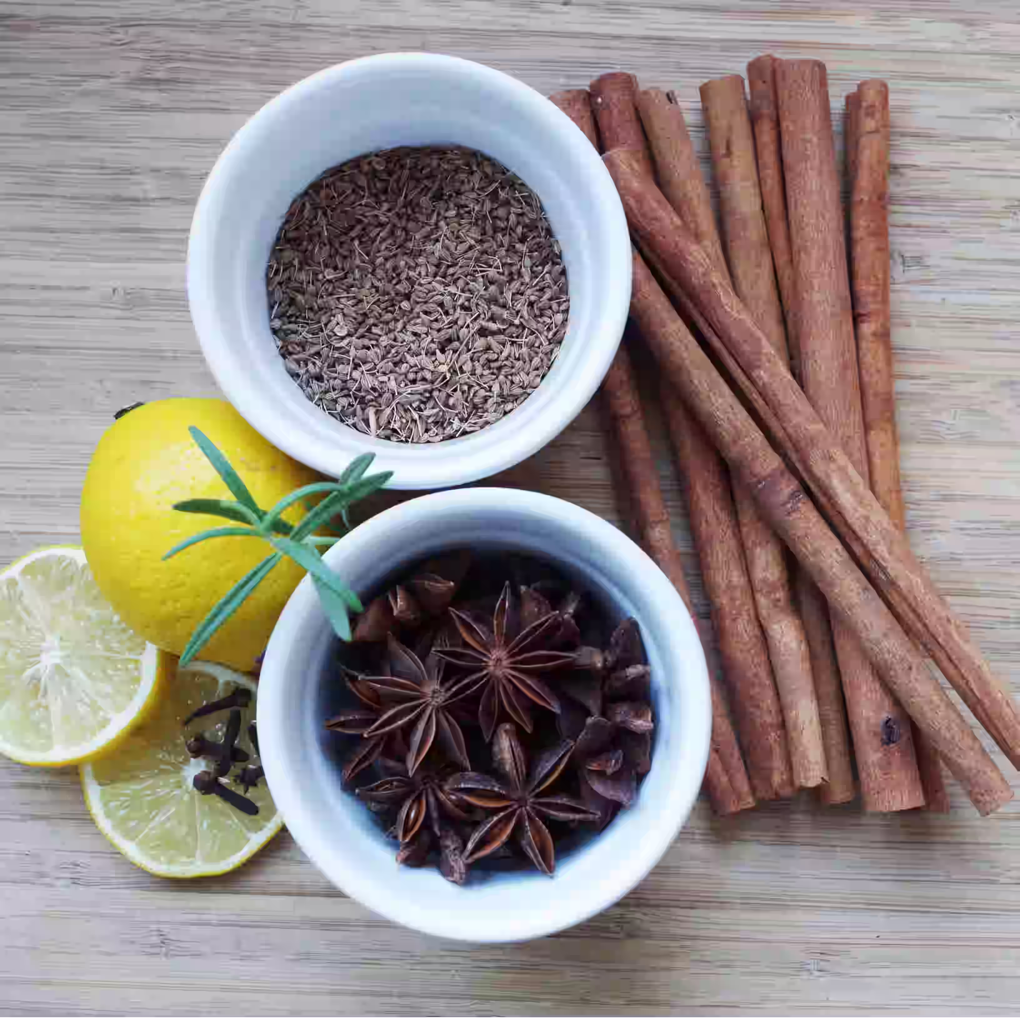 Star anise pods and anise seeds placed side by side with other spices to clearly show size and shape differences